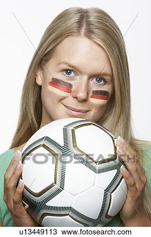 Stock Image - Young Female Sports Fan With German Flag Painted On Face. Fotosearch