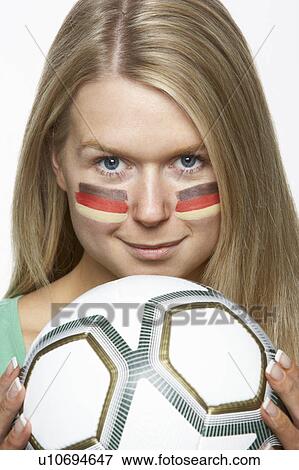 Stock Photo - Young Female Sports Fan With German Flag Painted On Face. Fotosearch