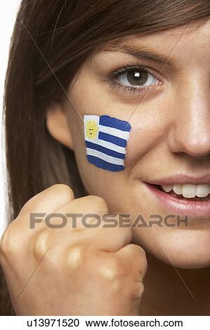 Stock Image - Young Female Sports Fan With Uruguayan Flag Painted On Face. Fotosearch