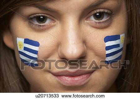 Stock Image - Young Female Sports Fan With Uruguayan Flag Painted On Face. Fotosearch