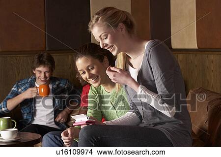 Picture - Young friends in cafÃ©. Fotosearch