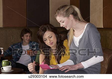Picture - Young friends in cafÃ©. Fotosearch