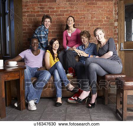 Stock Image - Young friends in cafÃ©. Fotosearch