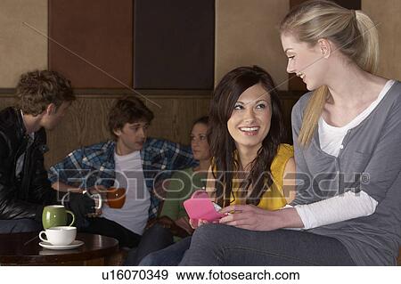 Young friends in café View Large Photo Image Stock Photo - Young friends in café. Fotosearch