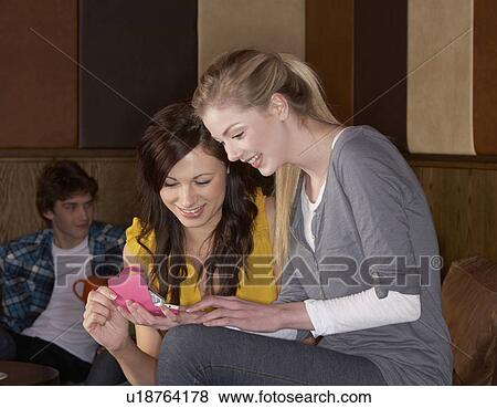 Young friends in café View Large Photo Image Stock Photo - Young friends in café. Fotosearch