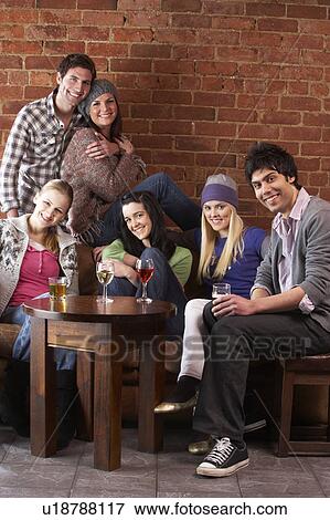 Stock Photo - Young friends in cafÃ©. Fotosearch