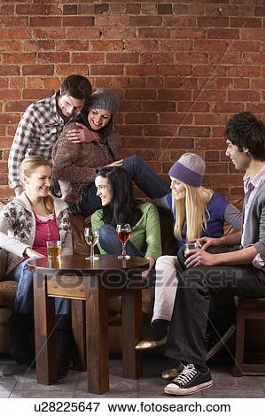 Young friends in café View Large Photo Image Stock Photo - Young friends in café. Fotosearch