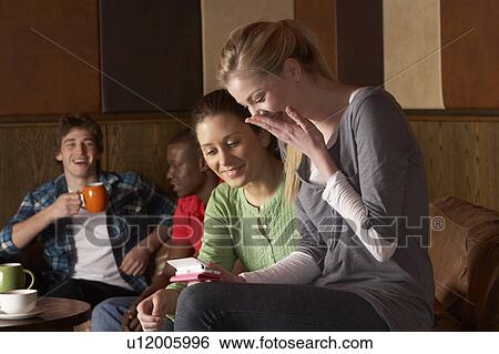 Young friends in café View Large Photo Image Stock Photograph - Young friends in café. Fotosearch