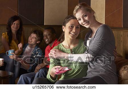 Stock Photograph - Young friends in cafÃ©. Fotosearch