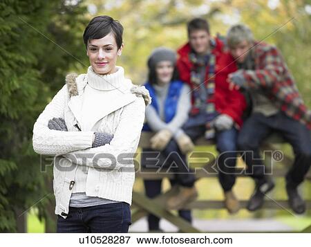 Young friends sitting on fence View Large Photo Image Stock Photo - Young friends sitting on fence. Fotosearch