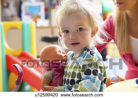 Stock Image - Young girl playing with toys. Fotosearch