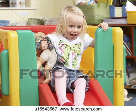 Stock Photo - Young girl playing with toys. Fotosearch