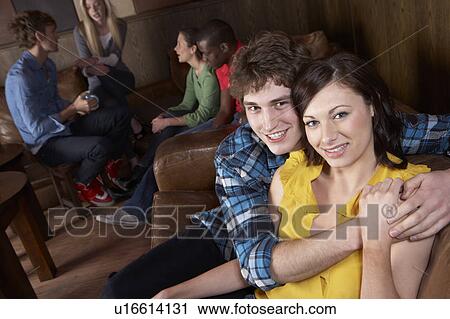 Stock Image - Young happy couple in cafe. Fotosearch