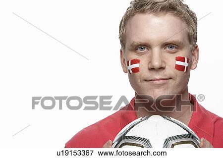 Stock Photo - Young Male Football Fan With Danish Flag Painted On Face. Fotosearch