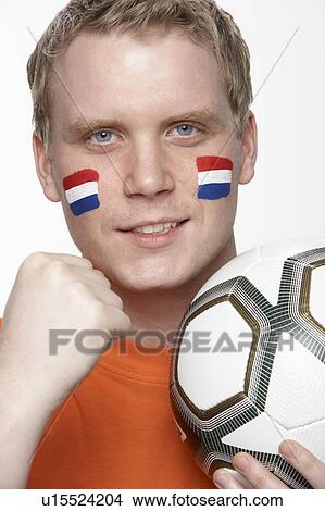 Young Male Football Fan With Dutch Flag Painted On Face View Large Photo Image Picture - Young Male Football Fan With Dutch Flag Painted On Face. Fotosearch