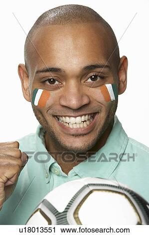 Young Male Football Fan With Ivory Coast Flag Painted On Face View Large Photo Image Stock Image - Young Male Football Fan With Ivory Coast Flag Painted On Face. Fotosearch