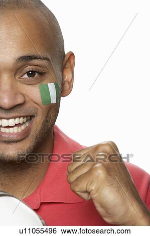Stock Photograph - Young Male Football Fan With Nigerian Flag Painted On Face. Fotosearch