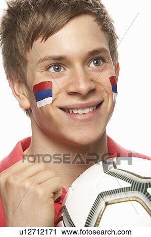 Stock Image - Young Male Football Fan With Serbian Flag Painted On Face. Fotosearch