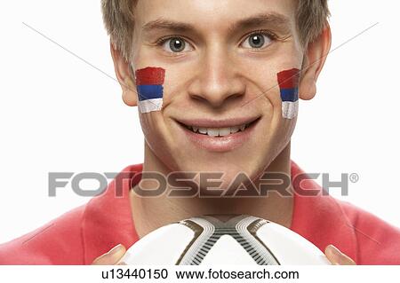 Stock Image - Young Male Football Fan With Serbian Flag Painted On Face. Fotosearch