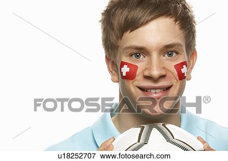 Young Male Football Fan With Swiss Flag Painted On Face View Large Photo Image Stock Photo - Young Male Football Fan With Swiss Flag Painted On Face. Fotosearch