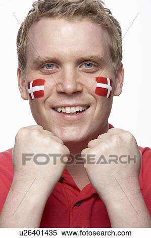 Stock Photography - Young Male Sports Fan With Danish Flag Painted On Face. Fotosearch