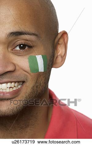 Young Male Sports Fan With Nigerian Flag Painted On Face View Large Photo Image Stock Photo - Young Male Sports Fan With Nigerian Flag Painted On Face. Fotosearch