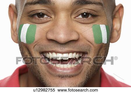 Young Male Sports Fan With Nigerian Flag Painted On Face View Large Photo Image Stock Photography - Young Male Sports Fan With Nigerian Flag Painted On Face. Fotosearch