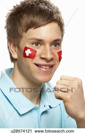 Stock Image - Young Male Sports Fan With Swiss Flag Painted On Face. Fotosearch