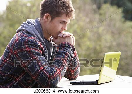 Picture - Young man with laptop computer. Fotosearch