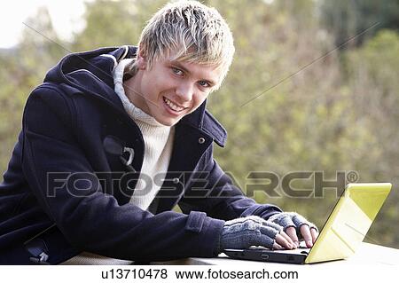 Young man with laptop computer View Large Photo Image Stock Photo - Young man with laptop computer. Fotosearch