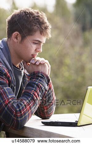Young man with laptop computer View Large Photo Image Stock Photo - Young man with laptop computer. Fotosearch