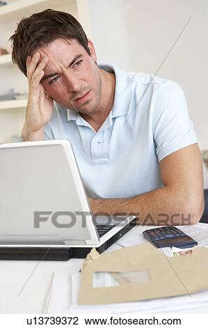 Young man working with laptop computer View Large Photo Image Stock Image - Young man working with laptop computer. Fotosearch