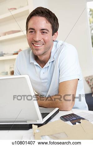 Young man working with laptop computer View Large Photo Image Stock Photo - Young man working with laptop computer. Fotosearch
