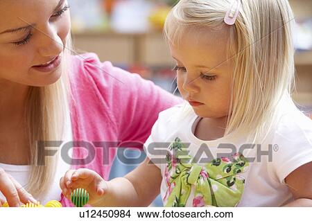Picture - Young woman playing with girl. Fotosearch