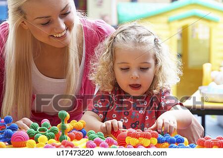 Young woman playing with girl View Large Photo Image Stock Image - Young woman playing with girl. Fotosearch