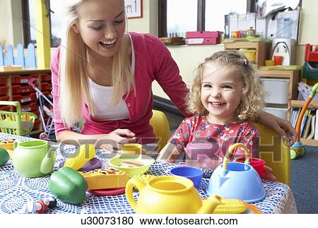 Young woman playing with girl View Large Photo Image Stock Image - Young woman playing with girl. Fotosearch
