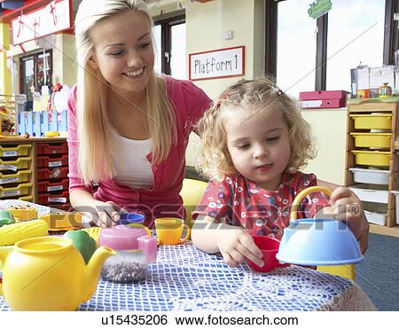 Young woman playing with girl View Large Photo Image Stock Photograph - Young woman playing with girl. Fotosearch