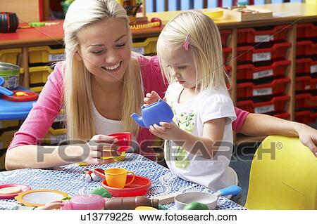 Stock Photography - Young woman playing with girl. Fotosearch