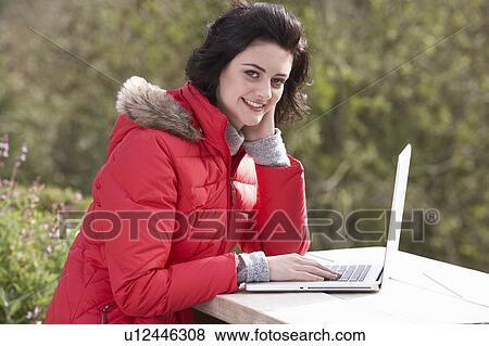 Stock Photo - Young woman with laptop computer. Fotosearch