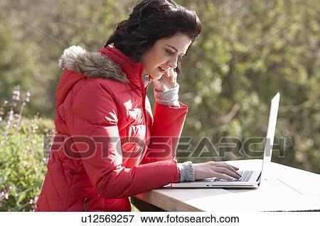 Young woman with laptop computer View Large Photo Image Stock Photo - Young woman with laptop computer. Fotosearch