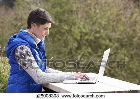 Young woman with laptop computer View Large Photo Image Stock Photo - Young woman with laptop computer. Fotosearch