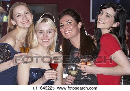 Young women drinking at bar View Large Photo Image Stock Photography - Young women drinking at bar. Fotosearch
