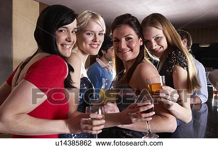Young women posing at party View Large Photo Image Stock Image - Young women posing at party. Fotosearch