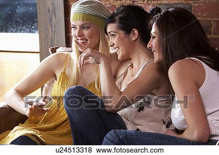 Stock Photo - Young women sitting together and talking. Fotosearch