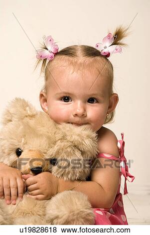 Stock Photo - baby girl with her teddy bear. Fotosearch