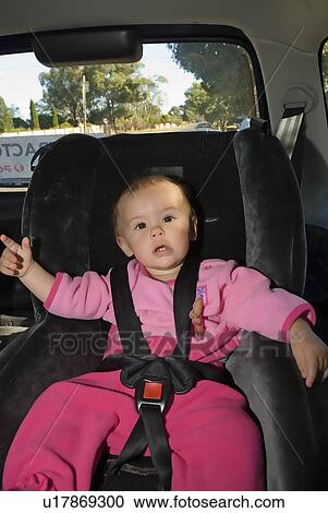 Stock Image - Baby in car seat. Fotosearch