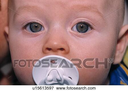 Stock Photo - Baby with a pacifier. Fotosearch