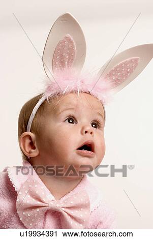 Stock Image - Baby with bunny ears. Fotosearch