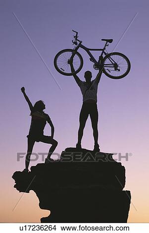 Biking to the top of a hill View Large Photo Image Picture - Biking to the top of a hill. Fotosearch