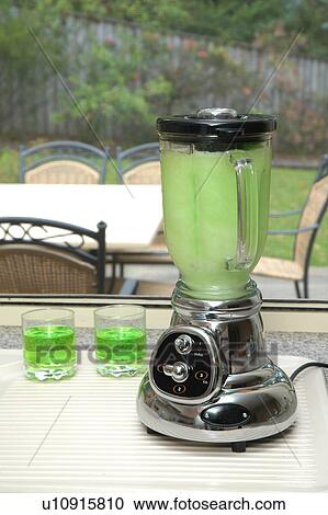 Stock Image - Blender with green beverage. Fotosearch